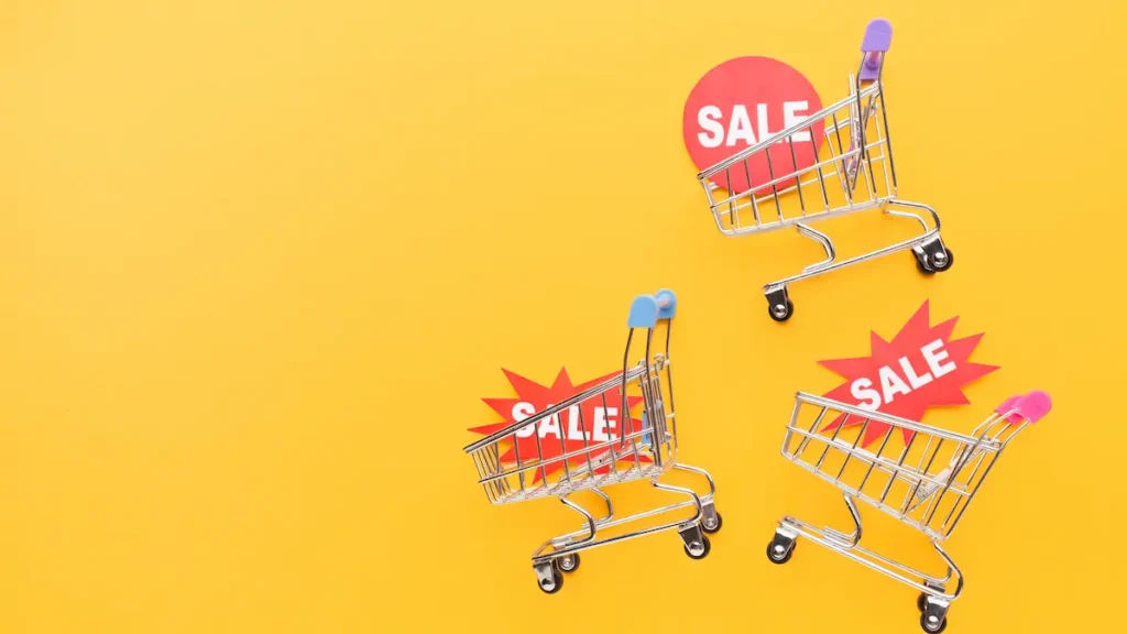 Datas duplas e ofertas relâmpago: saiba como evitar a compra por impulso nas promoções 3 Carrinhos de compras com placas de desconto representando promoções online e a importância de avaliar ofertas antes da compra.